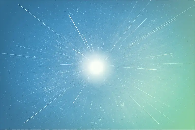 Direct shot of the sun with shooting stars surrounding it.